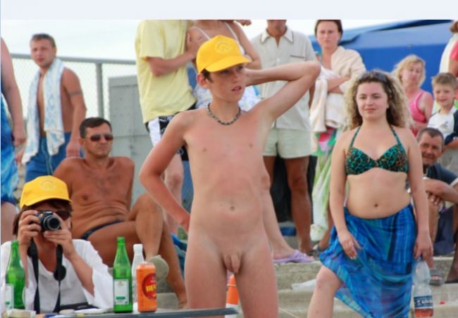 Nudists on a nudist beach in the summer [Nudism-Planet]